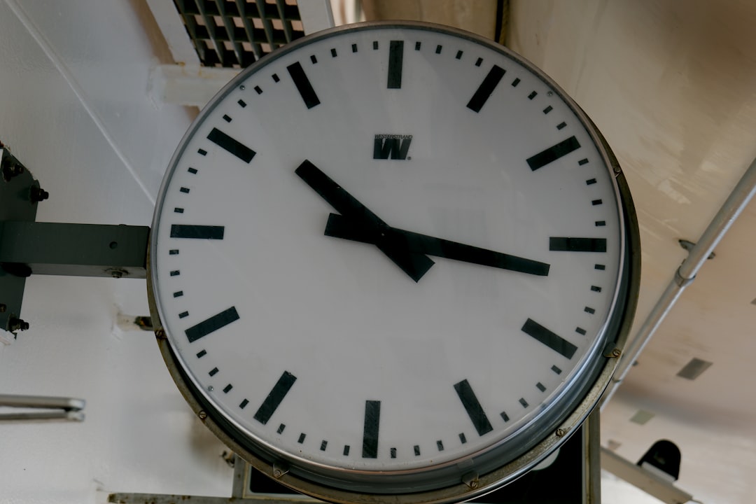 A large clock hanging from the side of a building
