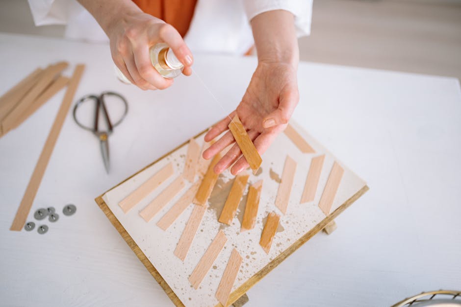 Close-up of crafting wooden wicks with a spray bottle, highlighting attention to detail and craftsmanship.