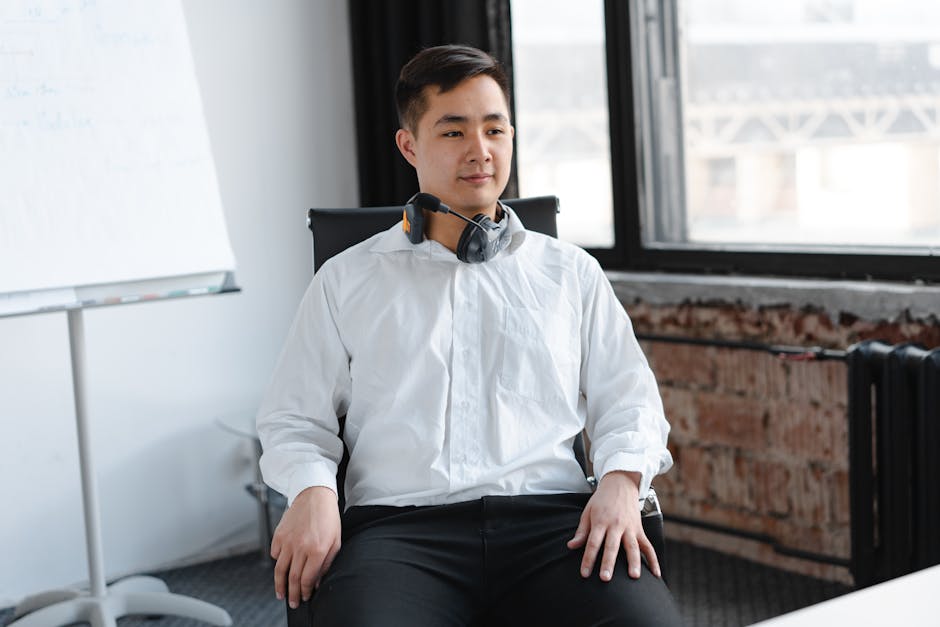 Professional call center agent wearing headphones in a modern office setting.