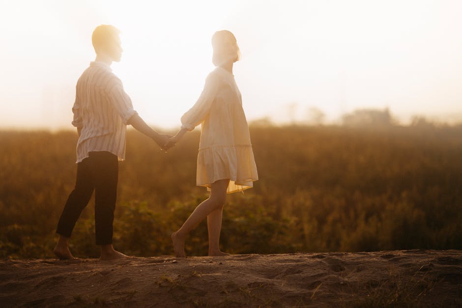 A loving couple holding hands during a sunset walk, creating a romantic and serene atmosphere.