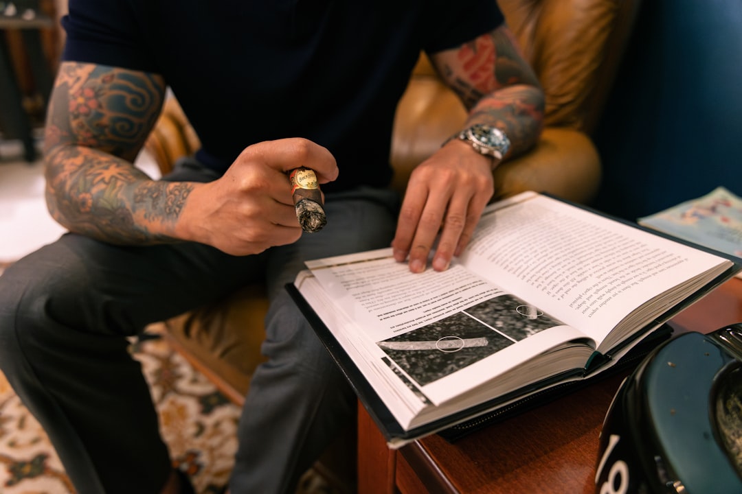 A man sitting on a chair holding a book