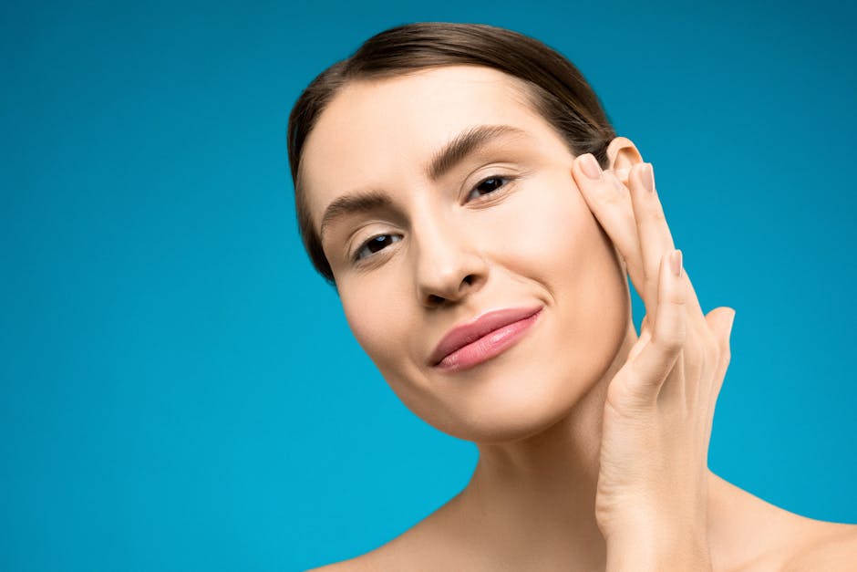 Happy woman with soft skin touching her face, portraying natural beauty.