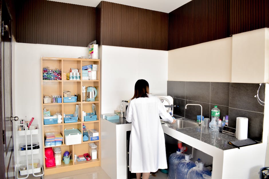 A female technician in a lab coat working in a well-organized laboratory setting.